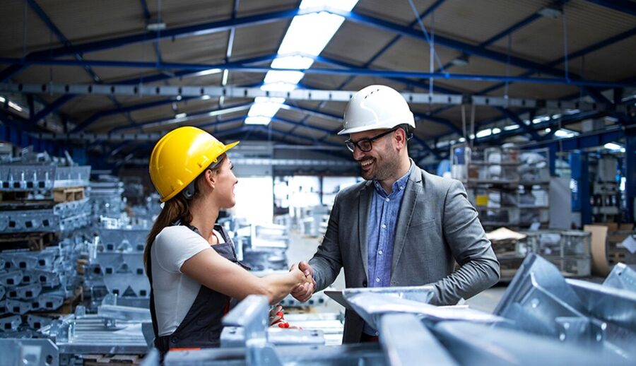 Factory manager and engineer shaking hands in a manufacturing plant, industrial IT and OT solutions by IT Traders Pune
